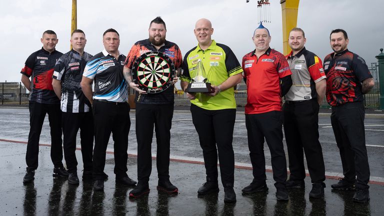 Stars of the Premier League darts line-up outside the iconic Goliath crane at the Harland & Wolff shipyard in Belfast
